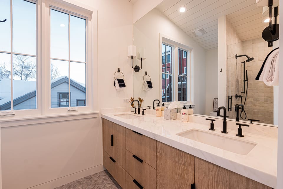 Top Floor Master 1 Suite with King size bed, private deck, 50" TV, and en suite bathroom with double sinks and tile & glass shower