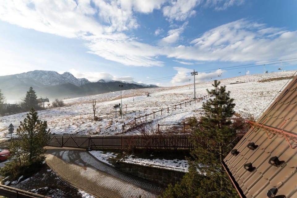 A picturesque chalet with classic mountain architecture, surrounded by scenic views of nature.