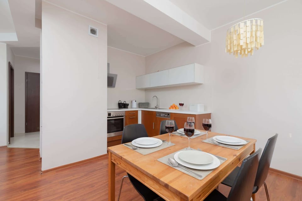 A kitchen with ample space, wooden elements, and white cabinetry creating a light and airy feel.