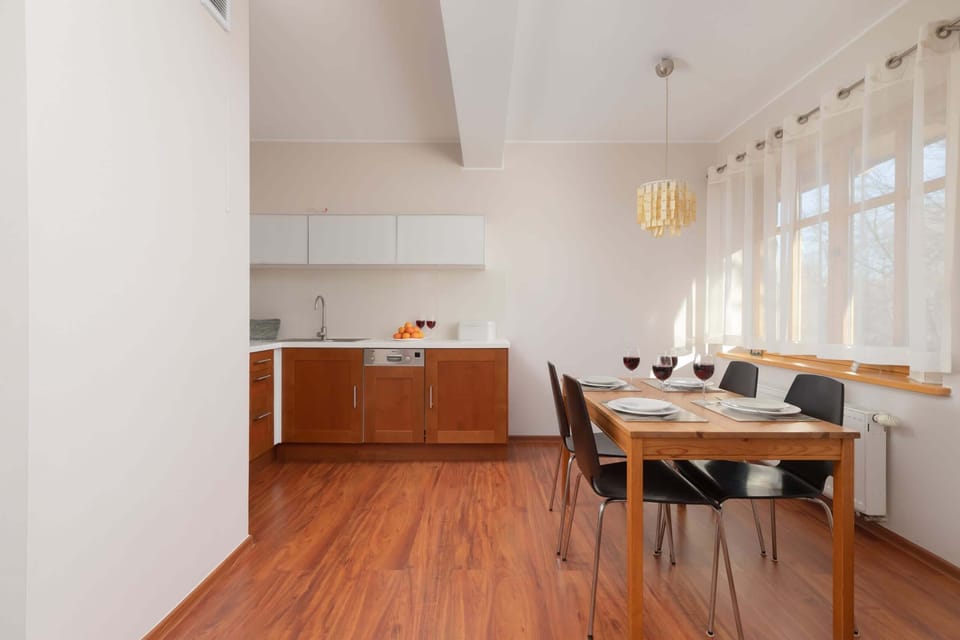 A kitchen with ample space, wooden elements, and white cabinetry creating a light and airy feel.