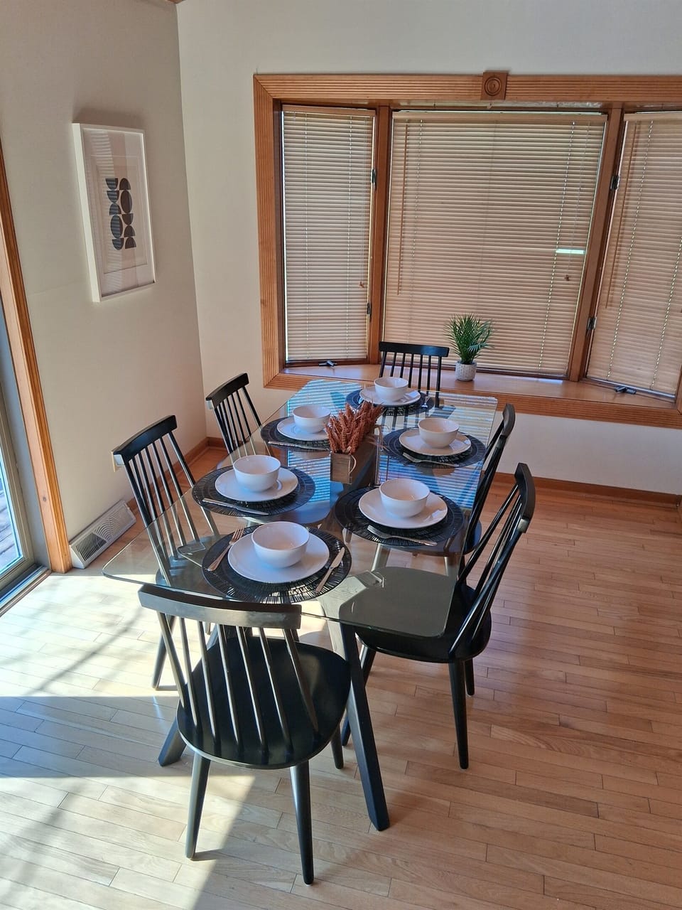 Dining table beside large windows
