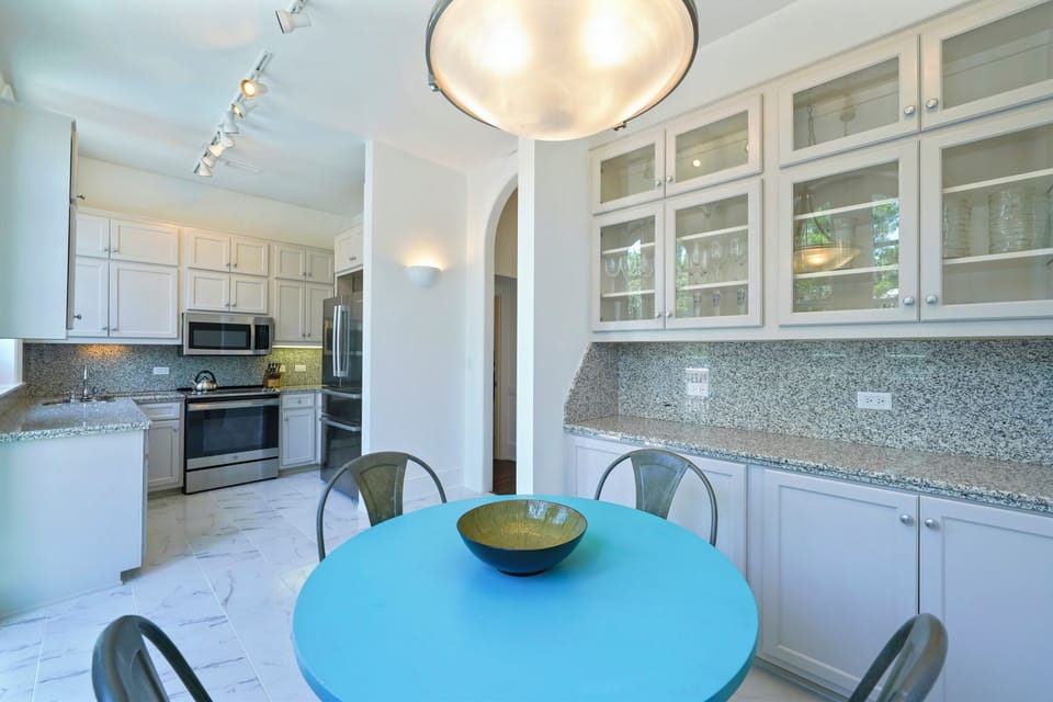 BREAKFAST NOOK FACING REAR BALCONY ACCESS; DINING SEATS FOUR