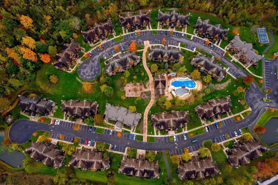 Resort-style community with sparkling pool and lush greenery