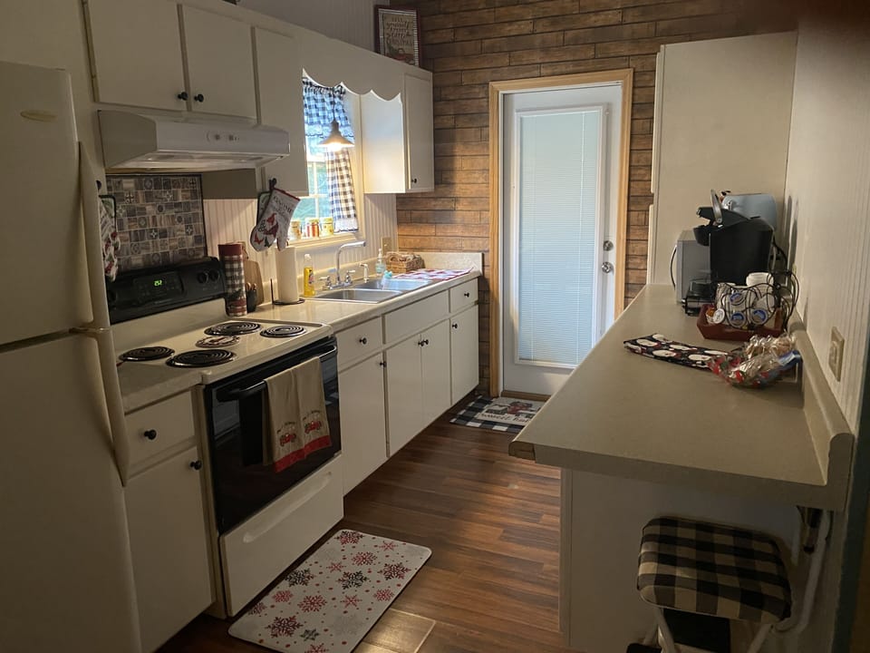 Galley style kitchen. Full size fridge, stove/oven, microwave, toaster, Keurig 