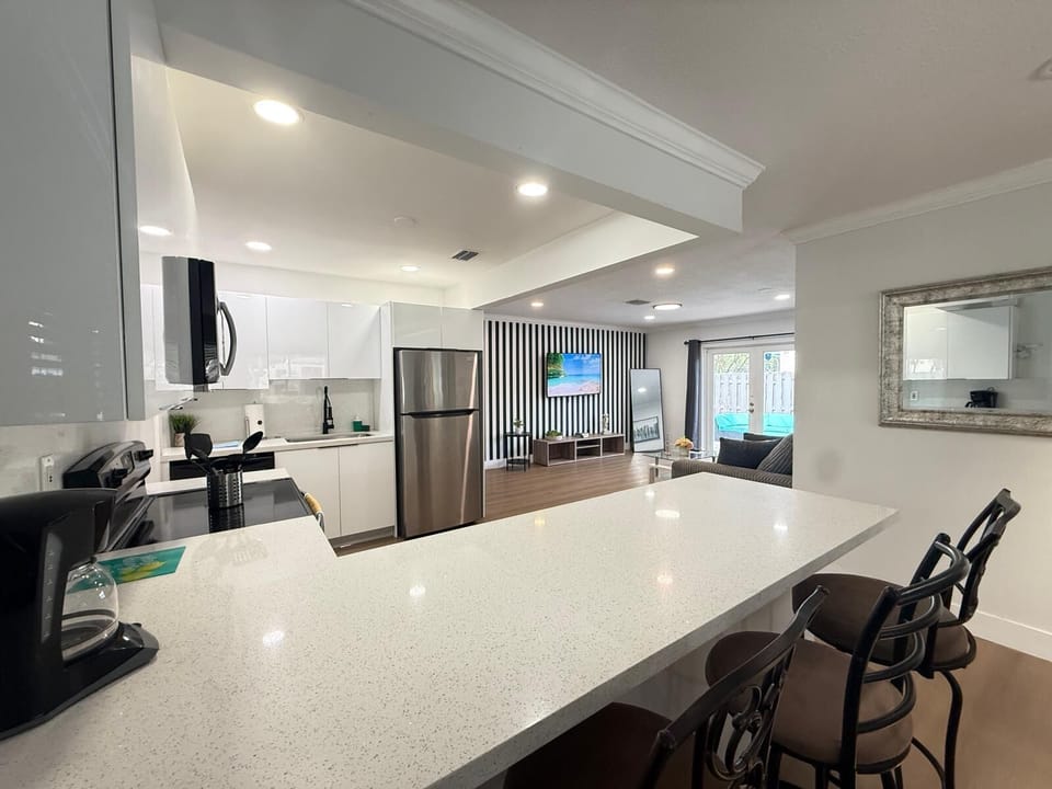Bright open kitchen with bar seating and stylish living space