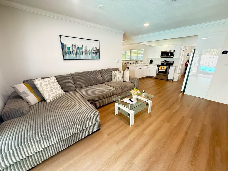 Bright open living space with oversized sectional and stylish kitchen