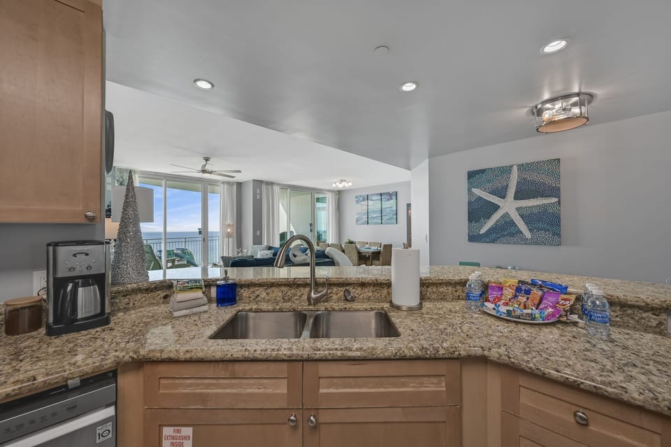 The updated kitchen has granite countertops, stainless steel appliances, and is fully stocked with more than the basics (coffee/tea bar, oils/spices, Tupperware, plenty of pots/pans/cookware)