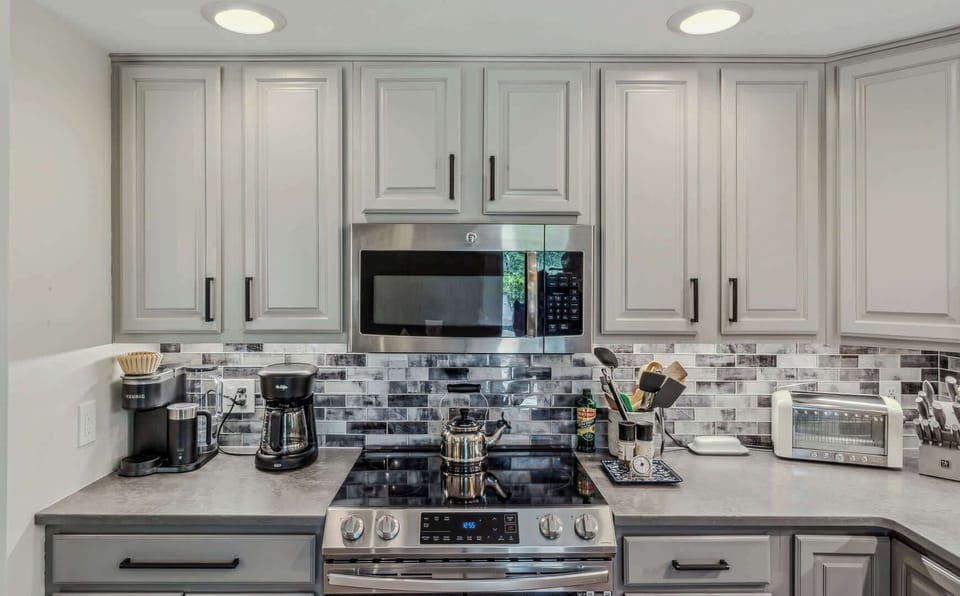 Coffee station with Keurig and drip coffee maker, glass-top stove, and microwave