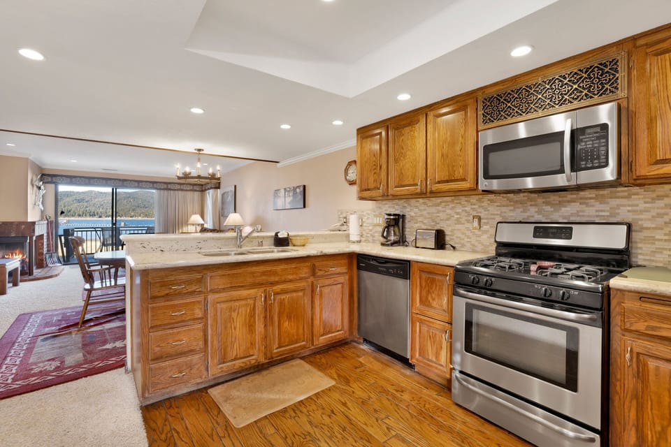 Fully equipped cabin kitchen with ample cabinetry, stove, fridge, microwave, and coffee maker—perfect for cooking meals, morning coffee, and feeling right at home on your stay.