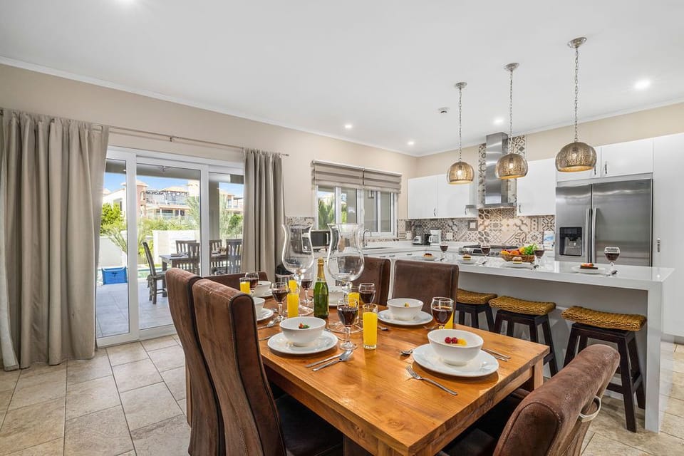 There is a 6-seater dining table with upholstered chairs.