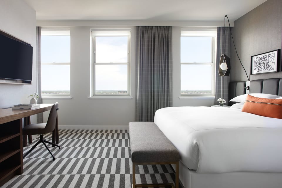 Settle in with city views, dedicated desk, and plush bed.