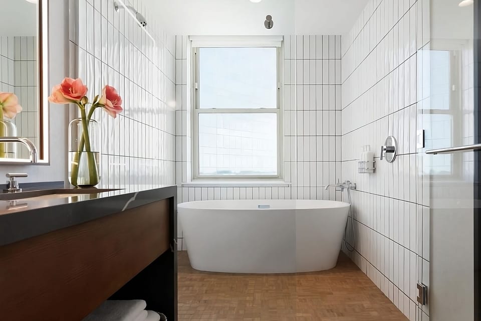 Soak in the deep freestanding tub beneath sunny windows.