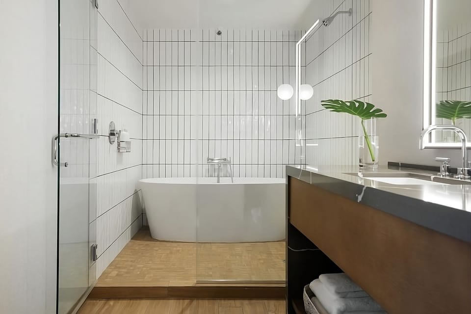 Refresh in a sleek spa-style bath with warm lighting.