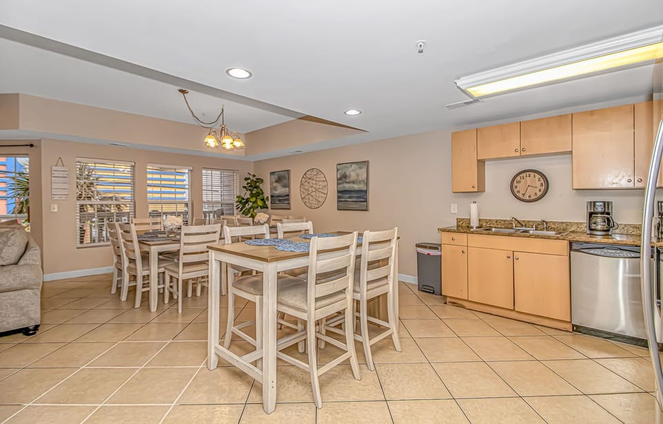 2 kitchen tables sit 12 and an additional high top table sits 4 more guests.