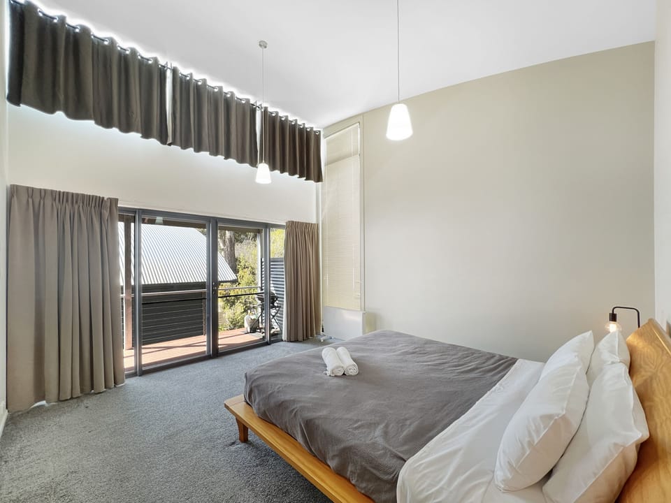 Retreat to the enchanting upstairs bedroom w/ a captivating glass door leading to a private balcony.