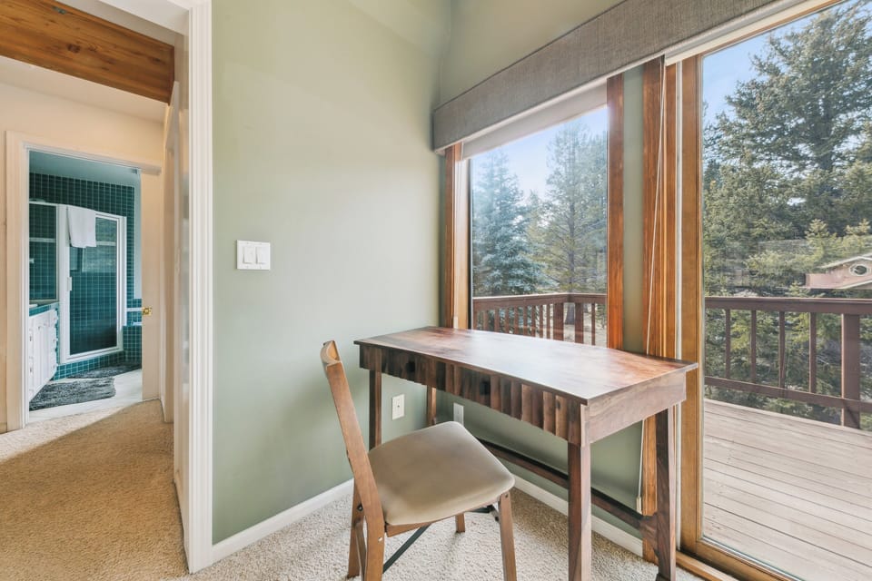 Your private workspace offers forest views and peaceful moments. The wooden desk provides the perfect spot for morning coffee or planning adventures.