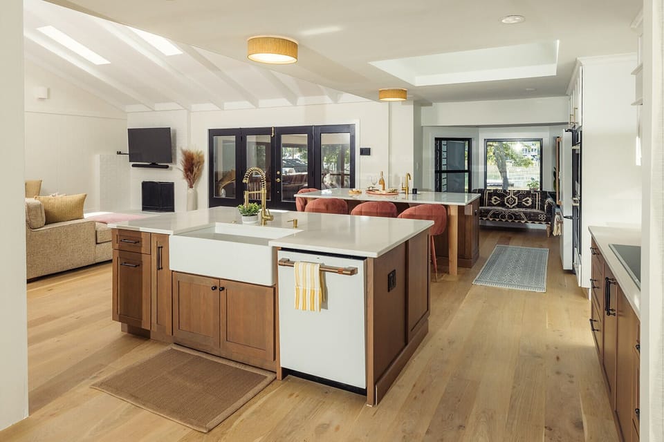 Main home Kitchen w/ double islands, farmhouse sink, electric range, double oven