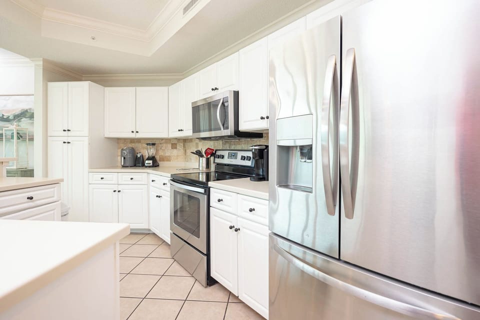 Prepare meals in this kitchen with elegant cabinetry, stainless appliances, and spacious countertops