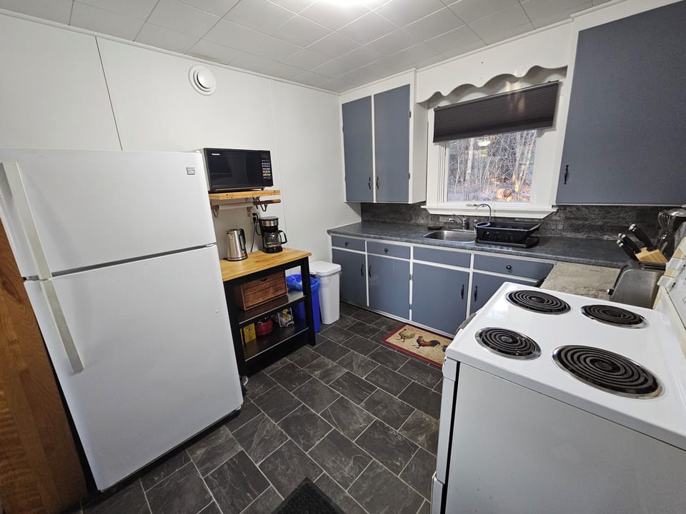 Kitchen with coffee maker, tea kettle, toaster, and dishwasher