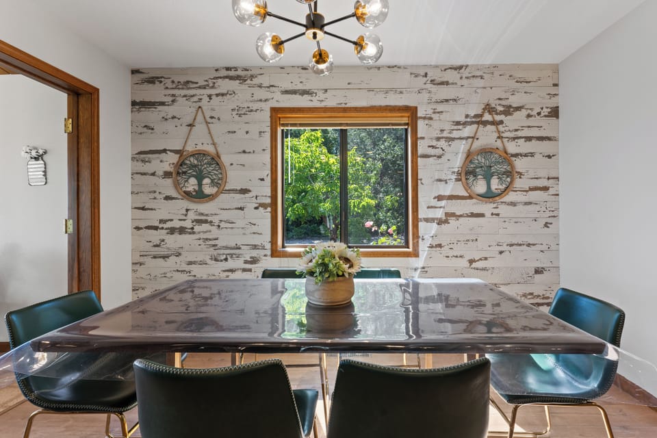 Bright modern dining space with garden views and rustic charm