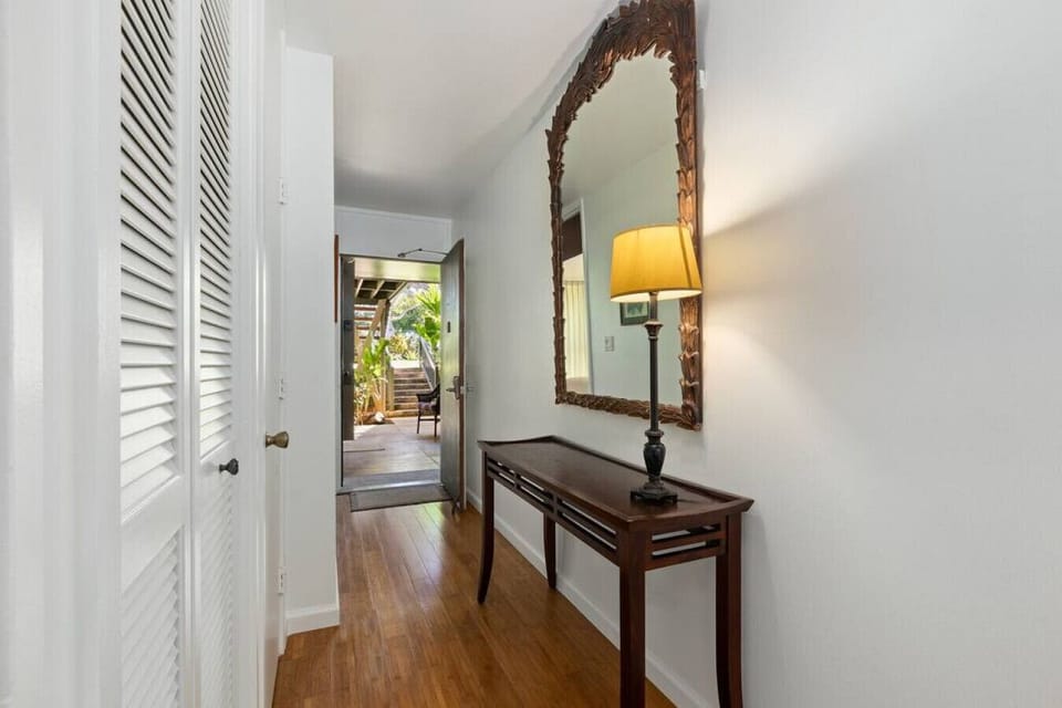 Bright entry hallway accented by warm light & simple decor.