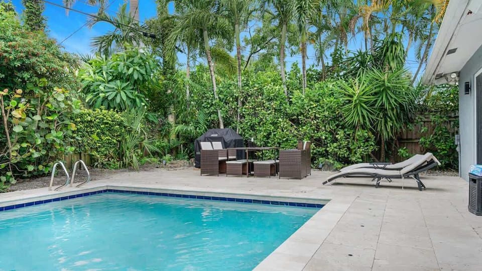Huge private outdoor space with a Pool, BBQ grills, lounge chairs, and outdoor table