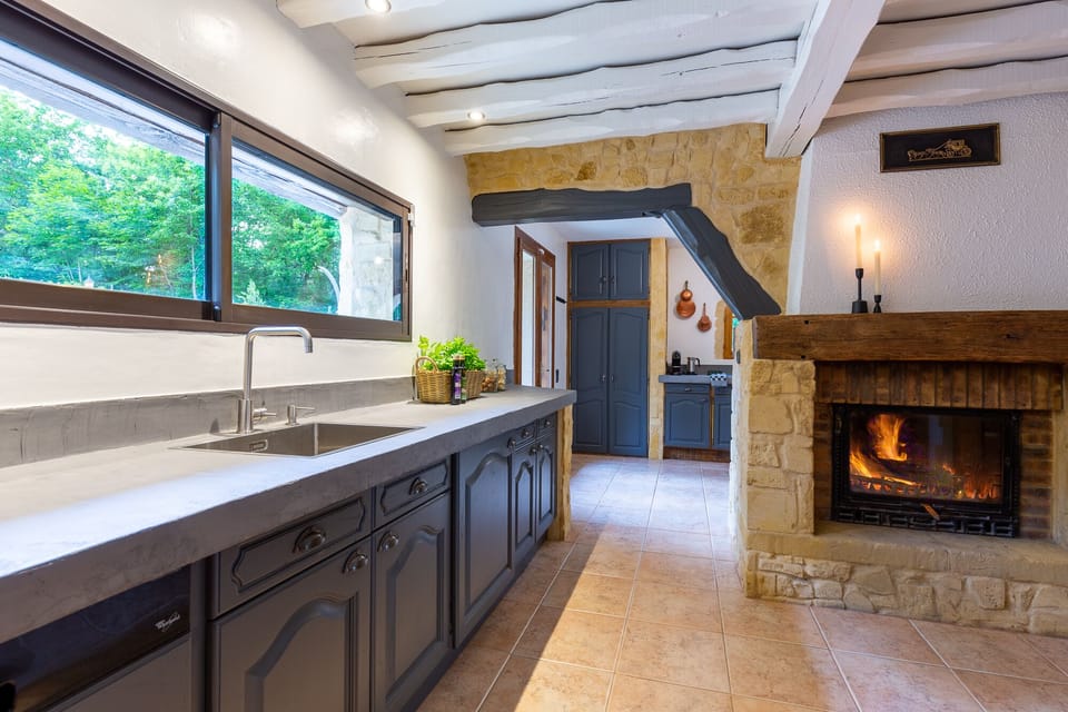 Spacious country kitchen with stone walls and garden views