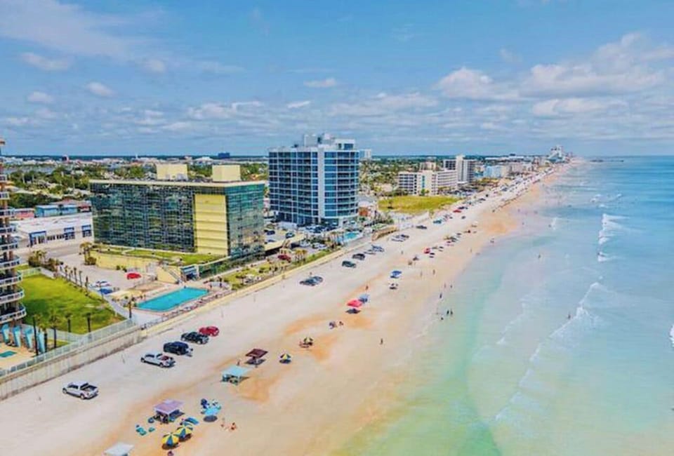 Beach parking in front of bldg steps to bathroom, pool, tiki bar, outside shower