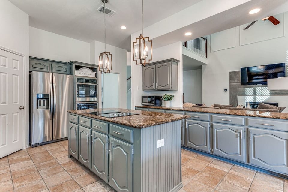 Gather 'round the kitchen island, set up snacks for your group along the counter, plenty of cookware and kitchen essentials for your group. 