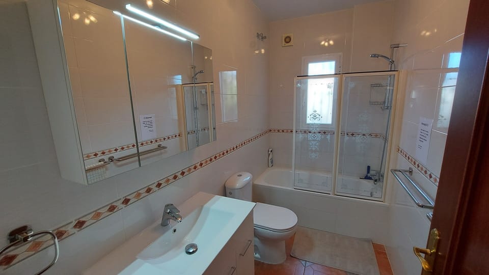 Bathroom 2 encompassing both a refreshing shower and a bathtub