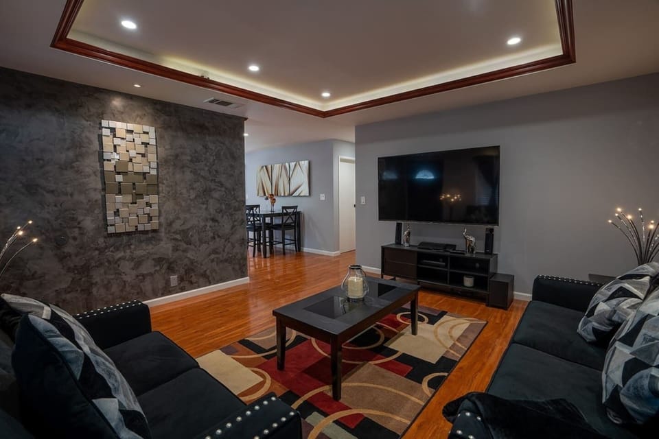 The living area with a large sofa and a TV