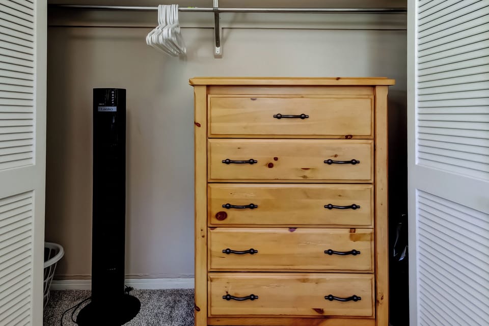 Dresser and fan located in closet