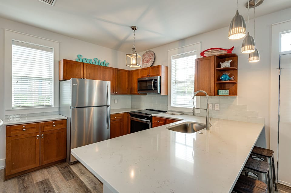 Kitchen is stocked with plenty of pots, pans and utensils, coffee maker.
