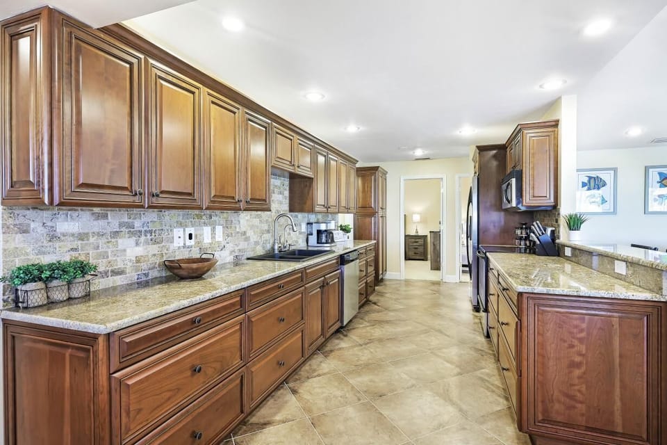 The spacious open plan Kitchen with wood cabinetry and granite countertops
