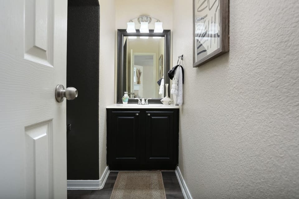 The exquisite downstairs half-bath is conveniently located next to the living room for easy access.