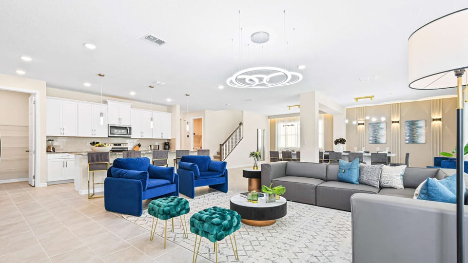 Modern open-concept living area with cozy seating, stylish kitchen, and elegant lighting.