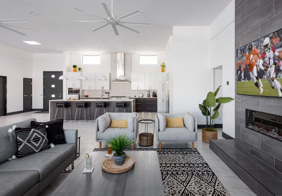 Designer furnished living room featuring large smart TV, and electric fireplace