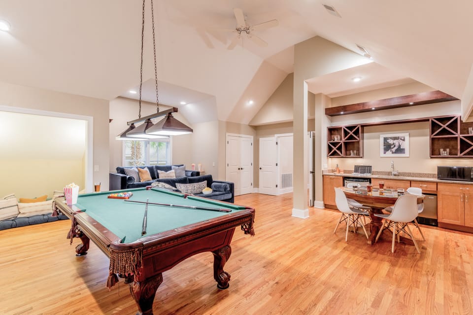 Recreation room features billiards, a card table, and a wet bar.
