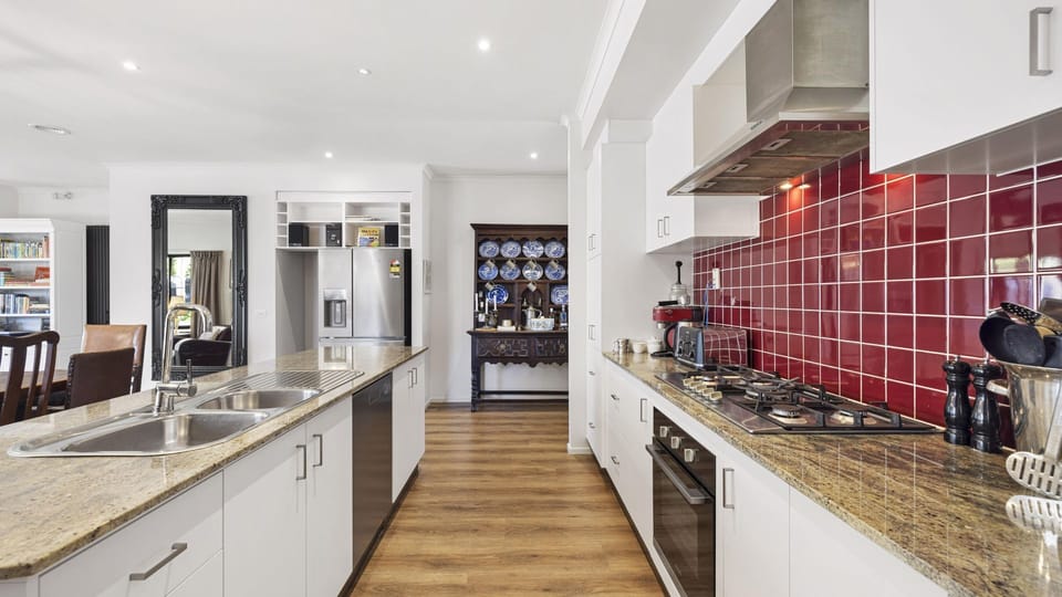 Open plan kitchen with stainless steel appliances. 
