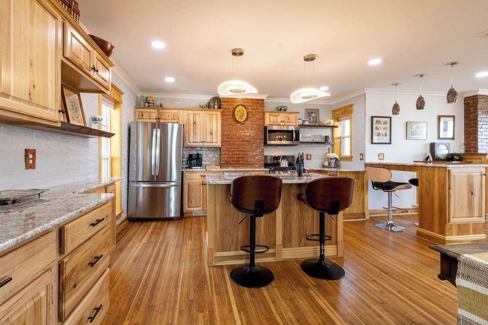 Fully stocked kitchen with an island, two stools, and a generous amount of counter space for a night in!