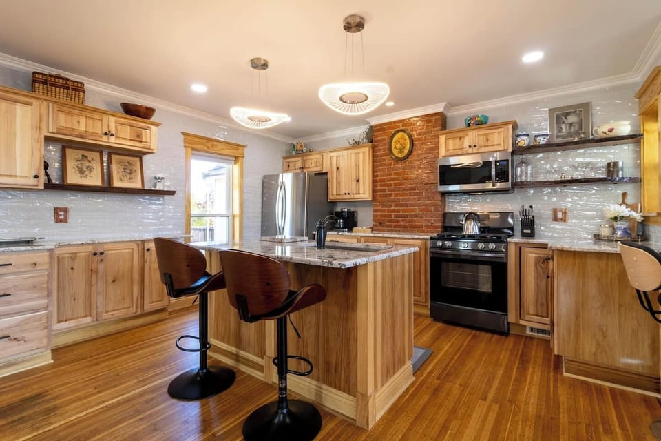 Modern fully stocked kitchen with a dishwasher, microwave, oven/stove, refrigerator, and all of the cooking essentials.