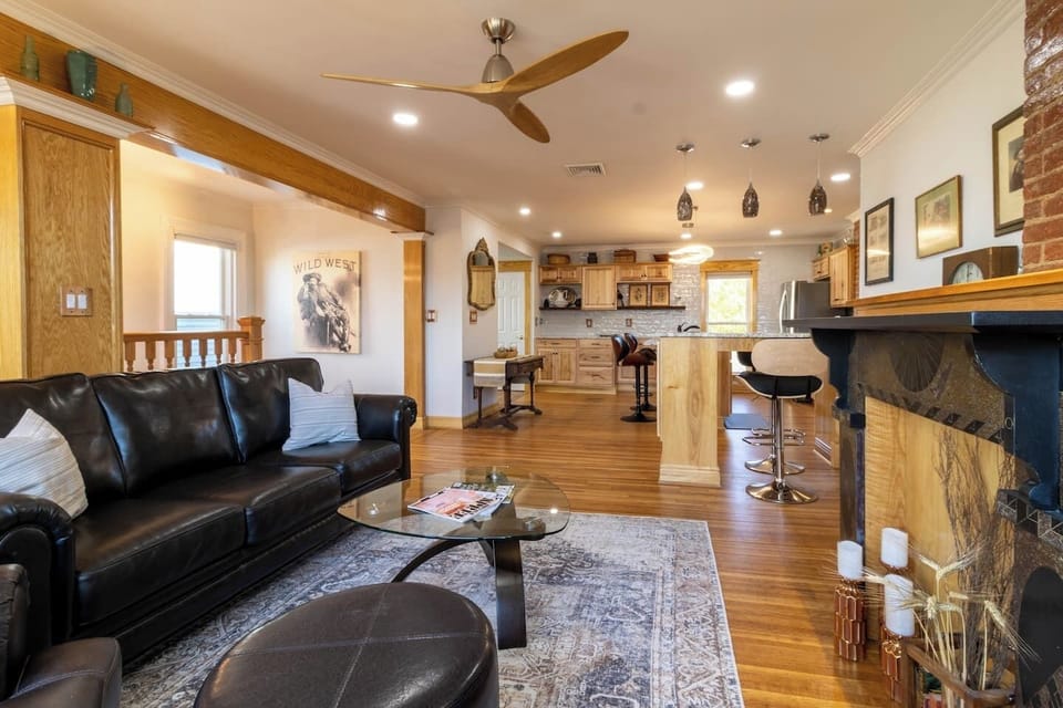 Open-concept living space and kitchen decorated with antiques.