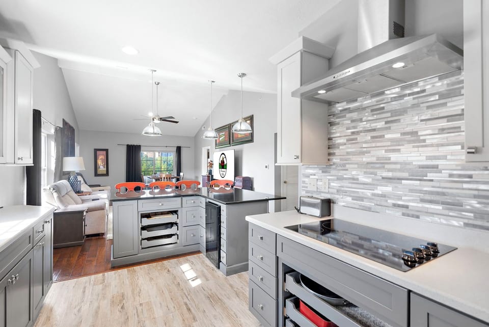 Fully equipped kitchen with upgraded appliances, wine cooler, and additional bar seating