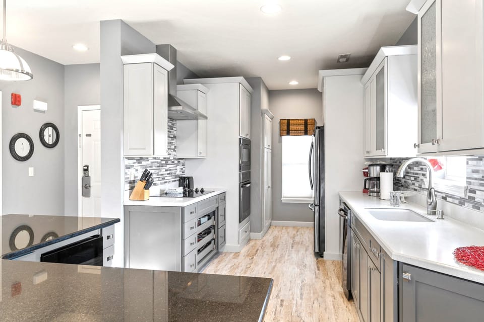 Fully equipped kitchen with upgraded appliances, wine cooler, and additional bar seating