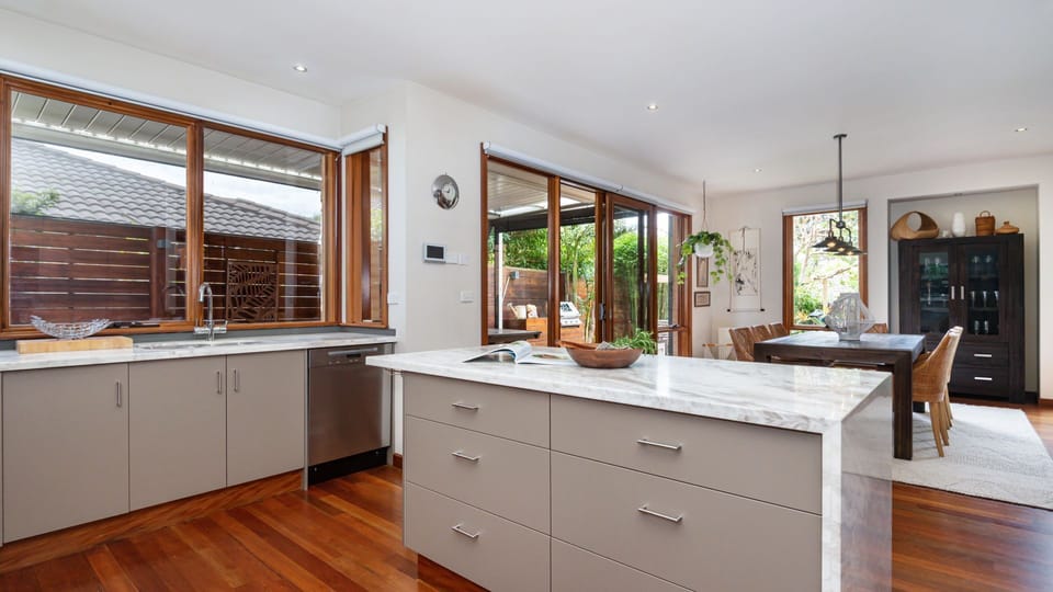 Kitchen - Island Bench looking out onto dining and deck