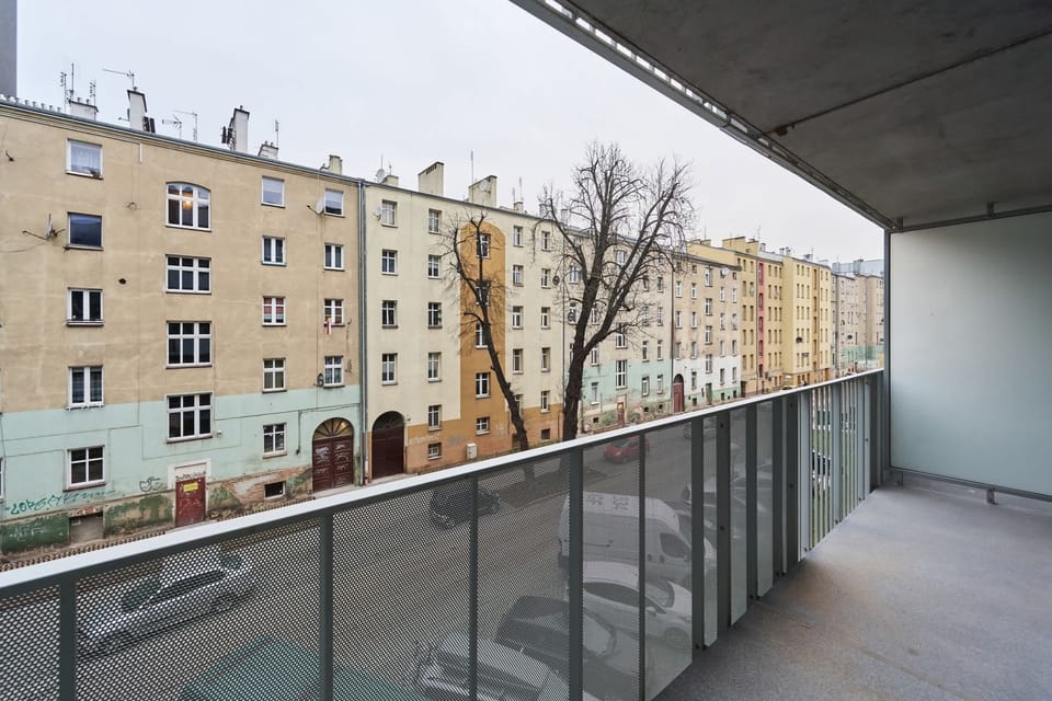 Spacious balcony with city view.
