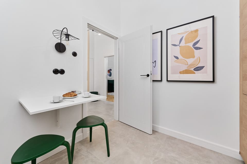 A sleek kitchen with wooden countertops, white cabinets, and a patterned backsplash, offering a modern and functional design.