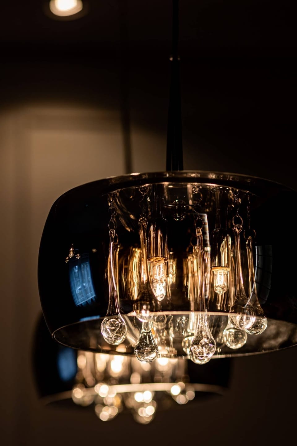 A stylish pendant light fixture hanging over a dining area, adding a warm ambiance.