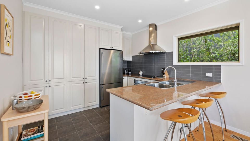 Preparing meals is made simple and easy with the kitchen's full amenities and modern equipment and appliances.