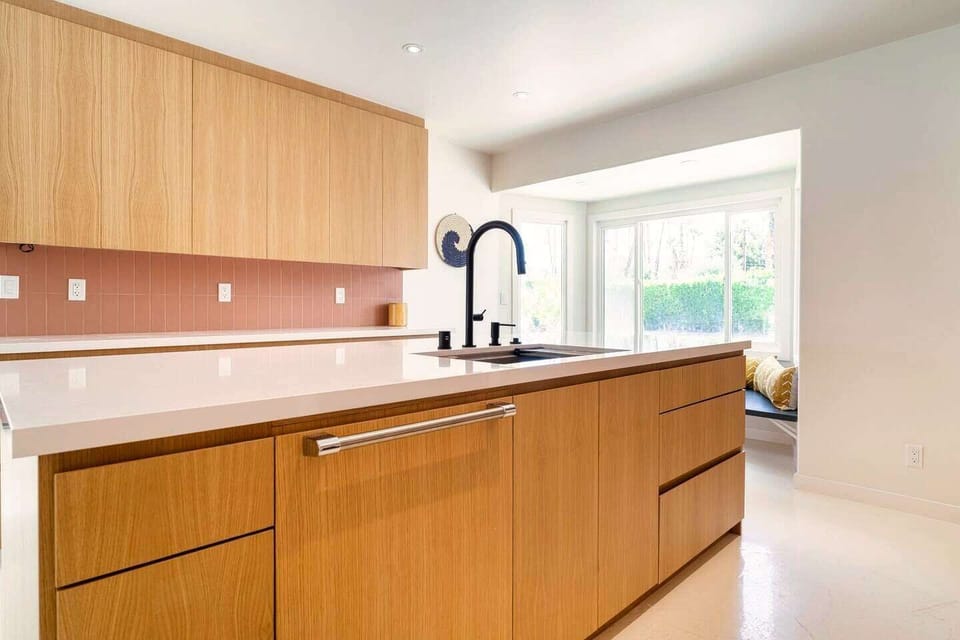 Kitchen with center island sink and integrated dishwasher.